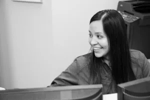 A woman of the front desk staff smiling